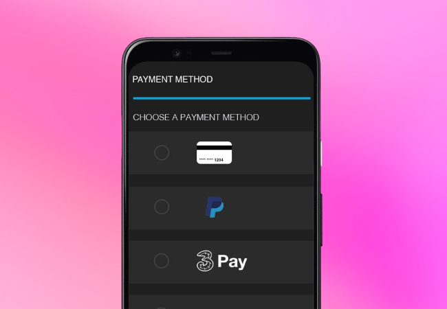 A smartphone displays a payment method selection interface. The title reads "PAYMENT METHOD" followed by "CHOOSE A PAYMENT METHOD". Three options are listed: a credit card, PayPal, and Three Pay. The background is a solid pink color.